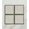Set of four cream ceramic coasters with dark green scalloped edges from Studio Bobbin ceramic holly collection