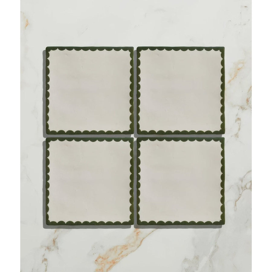 Set of four cream ceramic coasters with dark green scalloped edges from Studio Bobbin ceramic holly collection