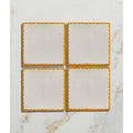 Set of four studio bobbin ceramic summer coasters with white centers and vibrant orange scalloped edges