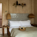 Studio Cosmos Midnight ceramic bed with a geometric white and black patterned tile headboard design
