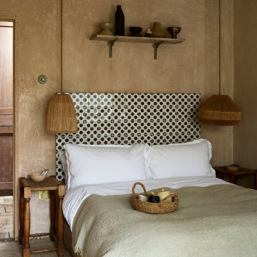 Studio Cosmos Midnight ceramic bed with a geometric white and black patterned tile headboard design