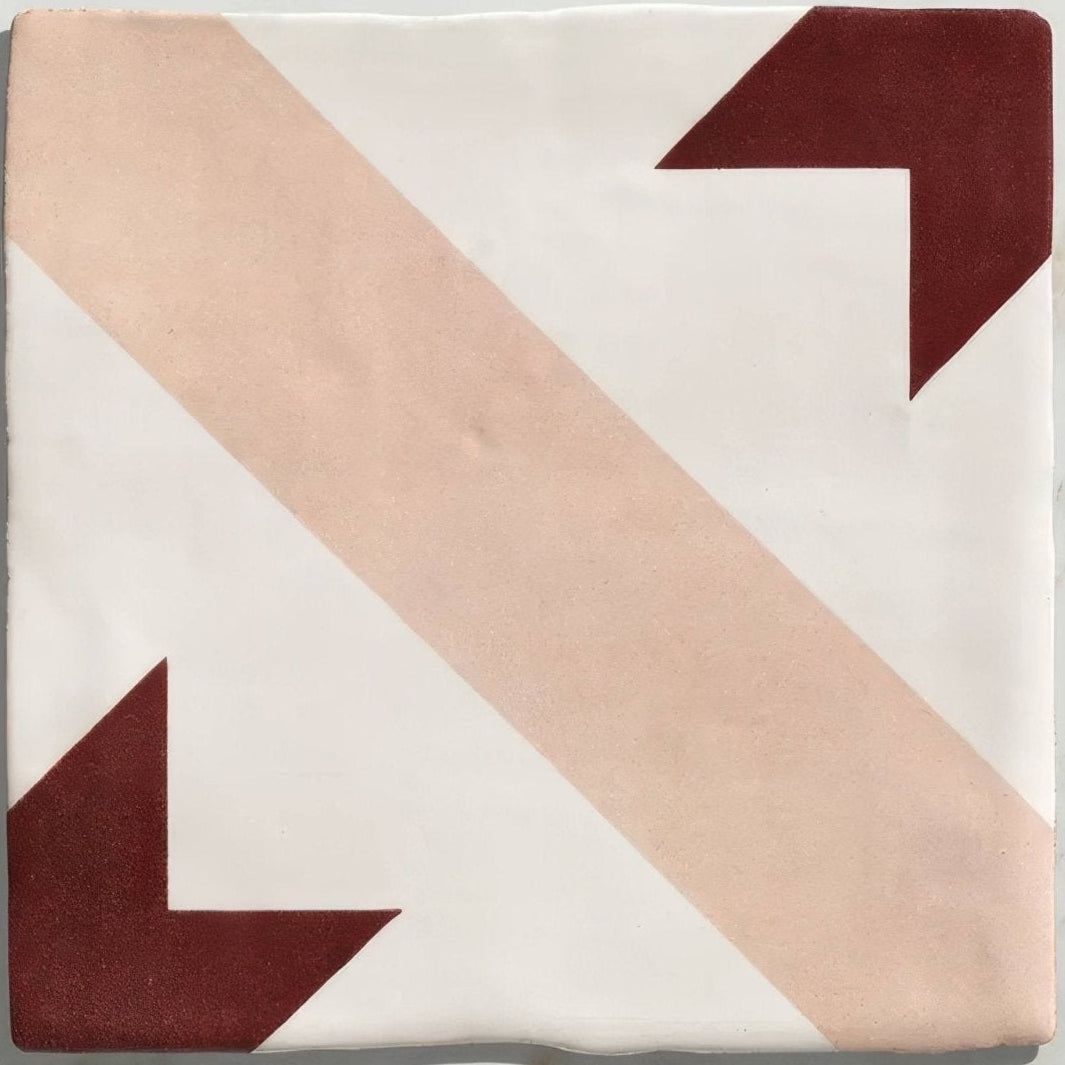 Studio étoile red star ceramic square tile with matte white surface and bold dusty rose and deep burgundy arrows