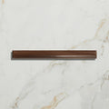 A sleek dark brown wooden drawer pull with smooth polished finish and subtle grain for studio jamboree chocolate beading