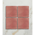 Four square matte terracotta tiles with earthy reddish-brown finish and subtle texture from studio jamboree coral field