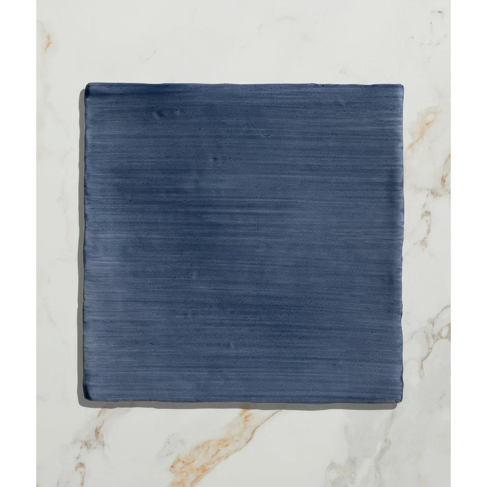 Studio jamboree handpainted ceramic denim field tile in deep blue with subtle horizontal texture and durable finish