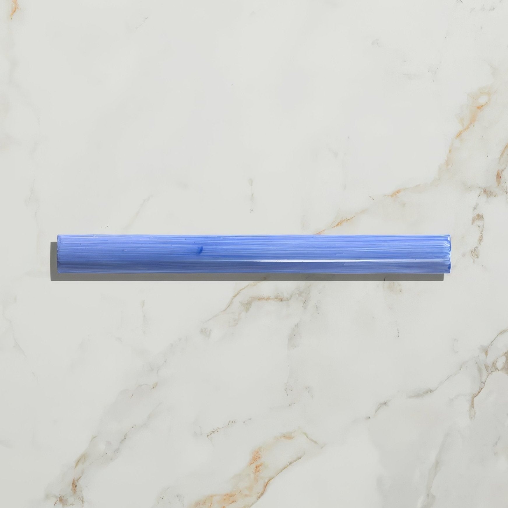 A translucent blue plastic straw with a textured surface and rounded edges featured in studio jamboree handpainted ceramic greek blue beading