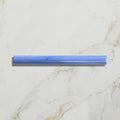 A translucent blue plastic straw with a textured surface and rounded edges featured in studio jamboree handpainted ceramic greek blue beading
