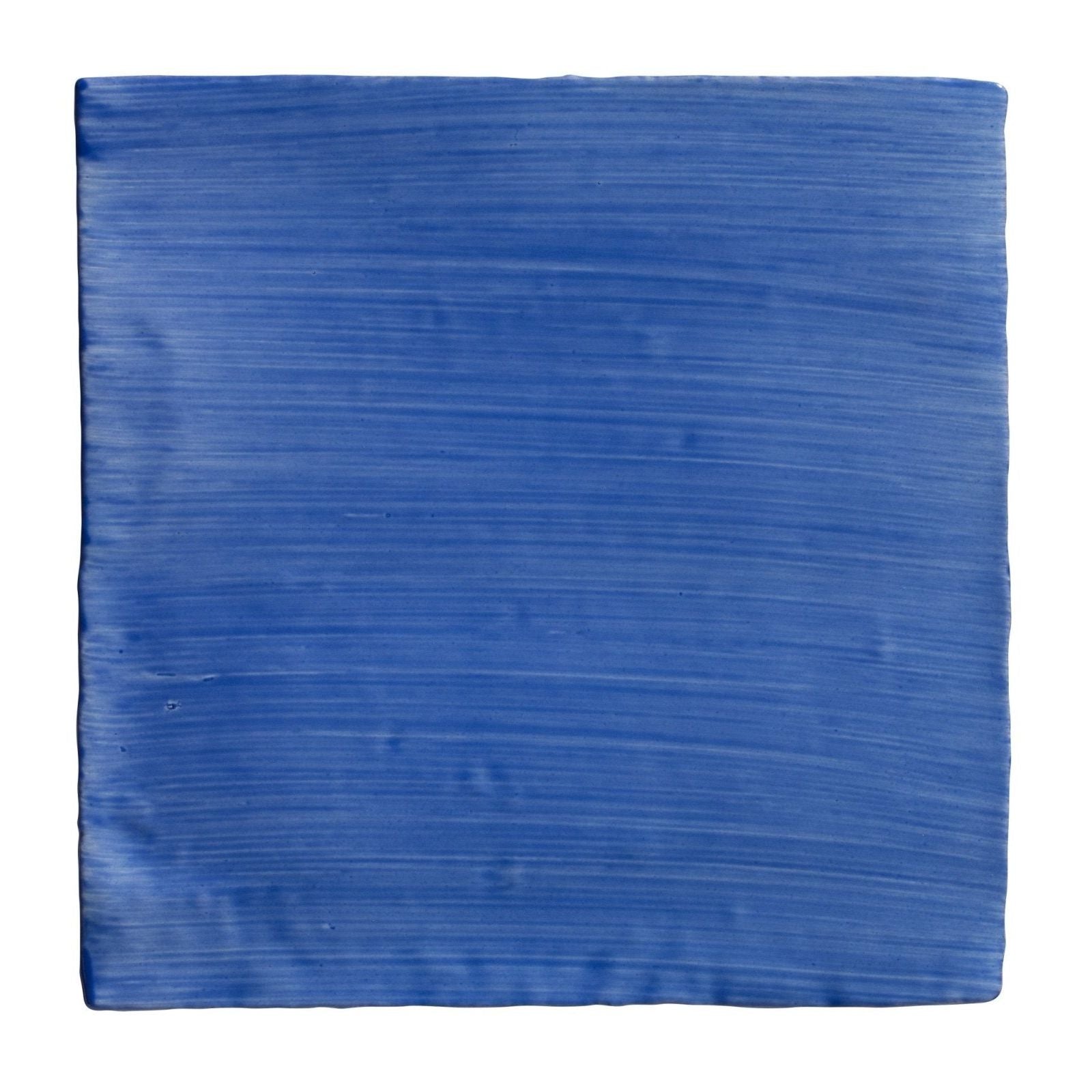 A square ceramic tile with vibrant blue glaze and horizontal brushstroke texture from Studio Jamboree Handpainted Greek Blue Field