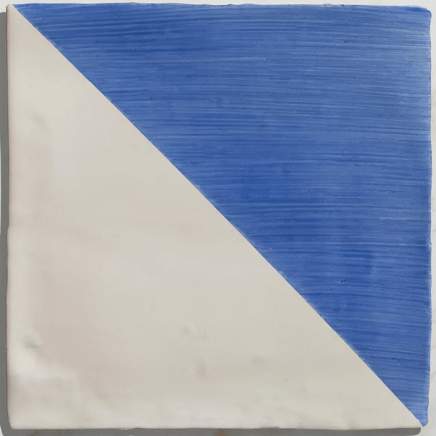 Square ceramic tile split diagonally with textured cobalt blue and smooth off-white in Studio Jamboree Greek Blue Tri design