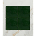Four square dark green handpainted ceramic tiles from studio jamboree holly field collection arranged in a grid