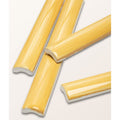 Yellow ceramic baseboard trim pieces with glossy finish and subtle wood grain texture from studio jamboree handpainted summer beading
