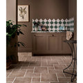 Studio jamboree handpainted ceramic thyme field brown tiled floor with white grout lines in a kitchen setting