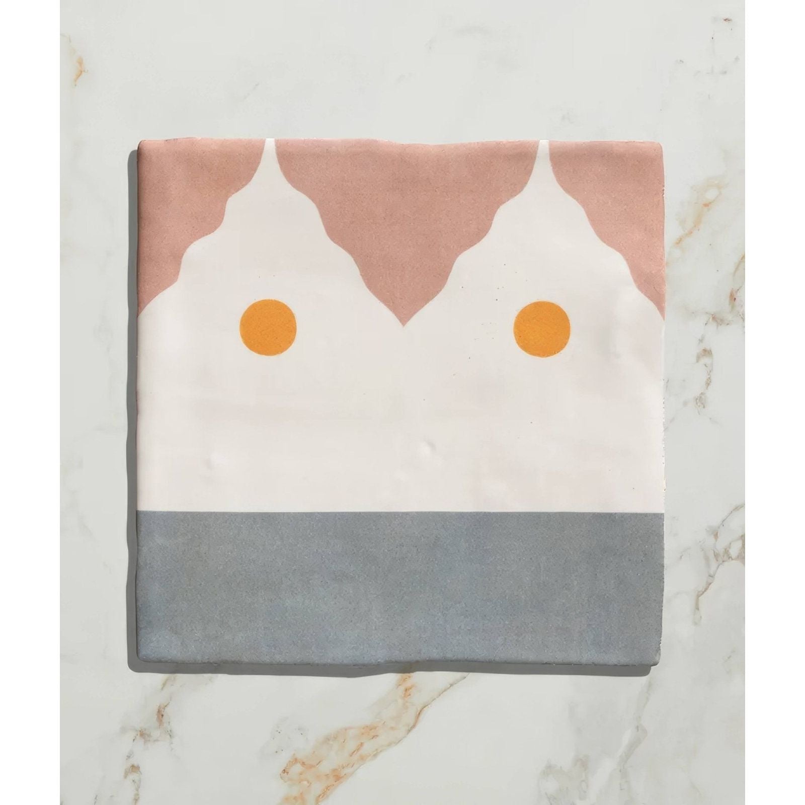 Studio Minaret yellow dot ceramic with soft pink white and gray geometric fabric square and two orange circular accents