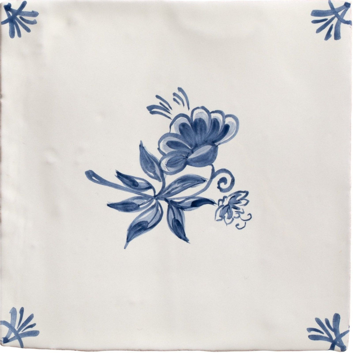 Studio Nonna’s Kitchen Classica ceramic tile cream colored with delicate blue floral and stylized leaf corner design