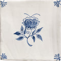 Cream-colored ceramic tile from studio nonnas kitchen classica with delicate blue floral design and corner motifs