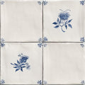 Four cream-colored ceramic tiles with delicate blue floral and leaf patterns from studio nonnas kitchen classica ceramic