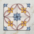 Four-square ceramic tile set with hand-painted yellow, blue, and muted pink floral design by Studio Nonna’s Kitchen Cornelia Ceramic