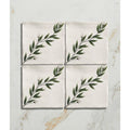 Set of four off-white ceramic coasters with delicate green leafy branch design by Studio Nonna Kitchen Floreale Ceramic
