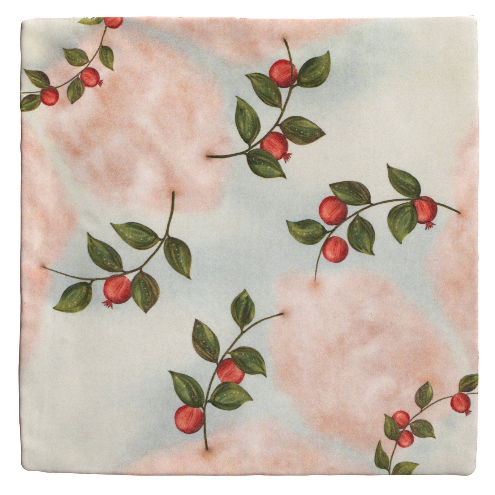 A square ceramic tile from studio nonnas kitchen nuvola melograno featuring delicate red berries and green leaves on soft pink and blue background