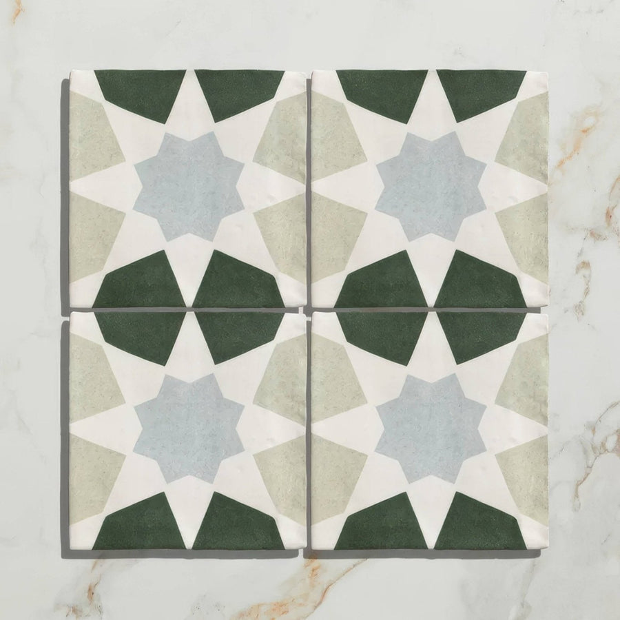 Four square studio souk blue star ceramic tiles with intricate star shaped geometric patterns in dark green gray blue and off white