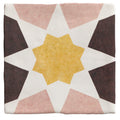 A square ceramic tile from Studio Souk featuring a geometric star pattern in muted pink dark brown and mustard yellow tones