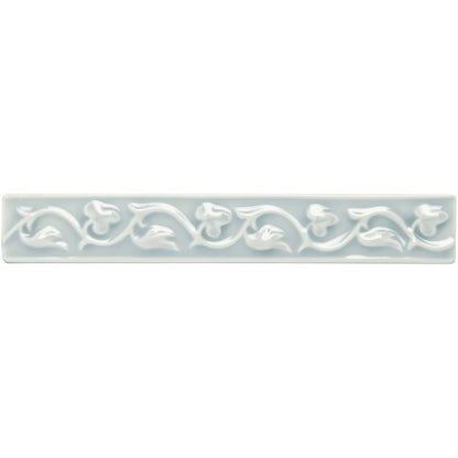A rectangular light gray ceramic tile with an embossed floral vine pattern from sudbury beaulieu