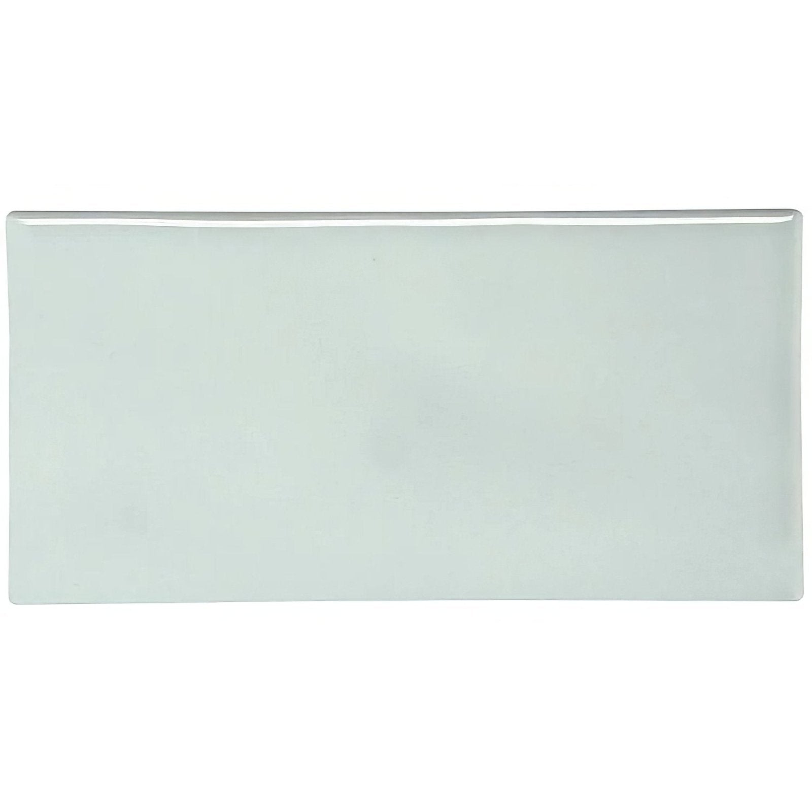 A sleek rectangular ceramic sudbury half tile with smooth glossy surface and soft pale green hue