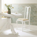 White wooden dining chair with beige upholstered seat and ornate carved legs shown for Sudbury Half Tile product