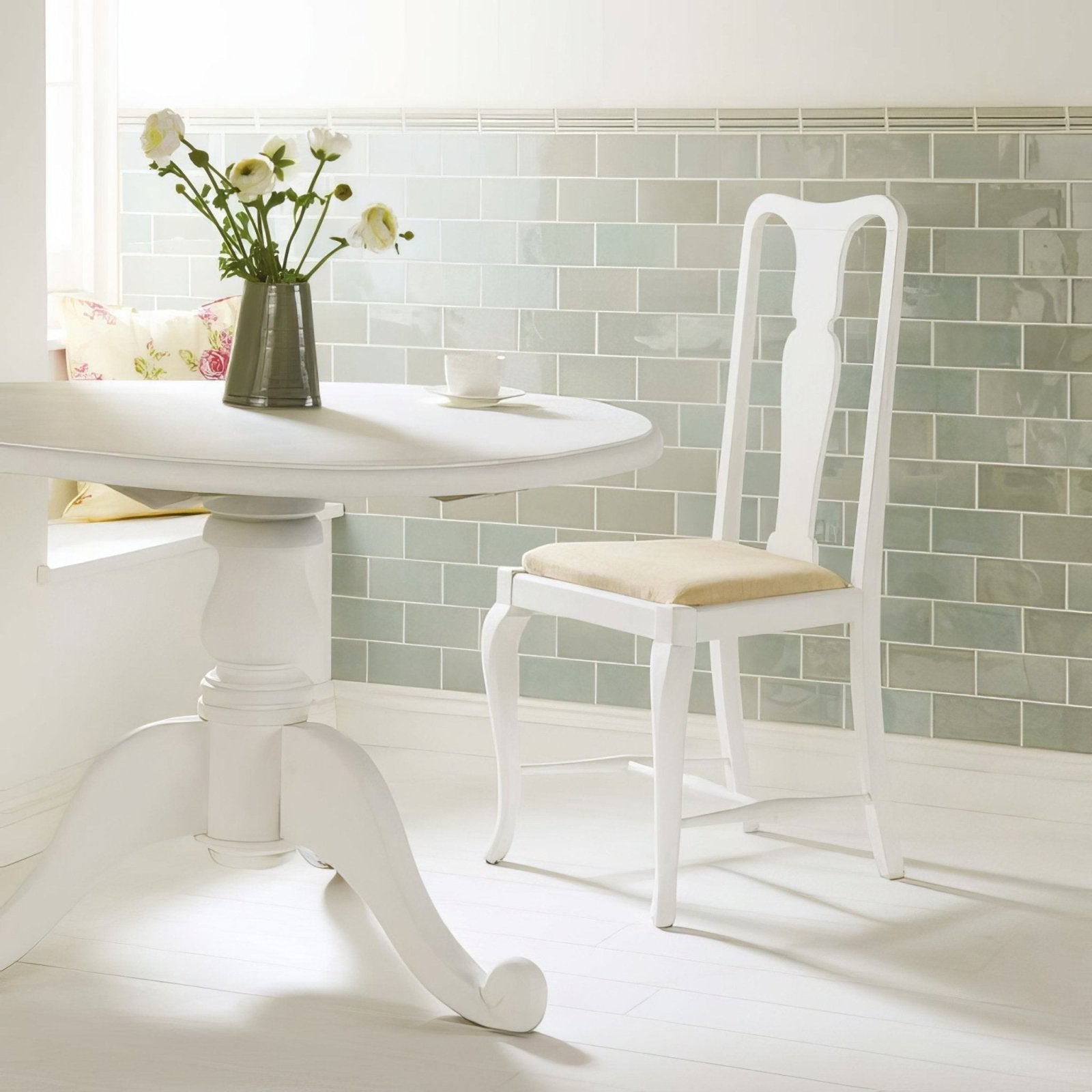 White pedestal dining table with curved legs and round top from the Sudbury Hampton collection