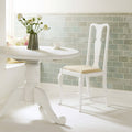 White pedestal dining table with curved legs and round top from the Sudbury Hampton collection