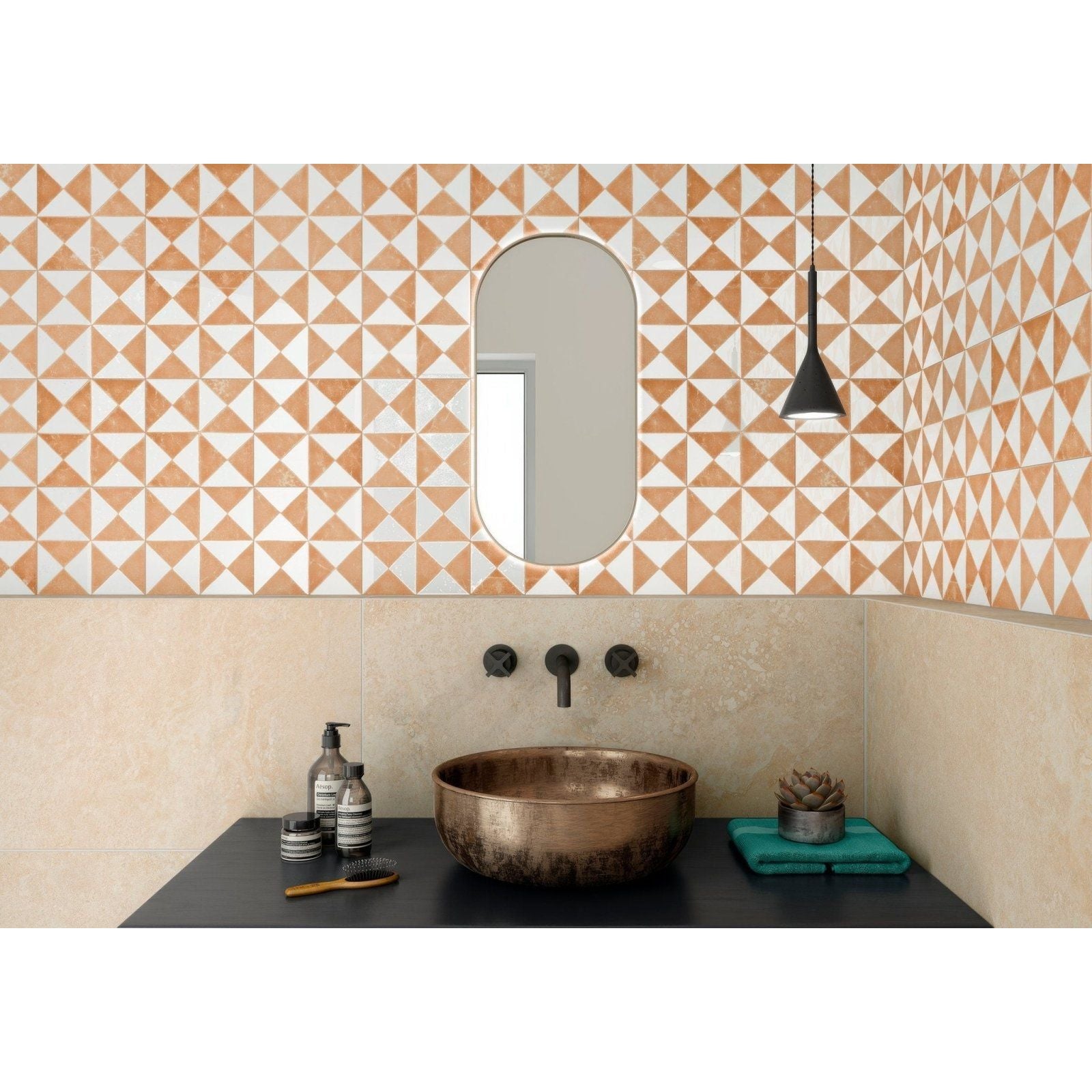 Bronze bowl sink in sunset orange with a matte slightly tarnished finish and rounded edges for bathroom use