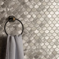 Surtur silver brushed scale aluminium mosaic tile wall in silver with black towel ring holding white textured towel
