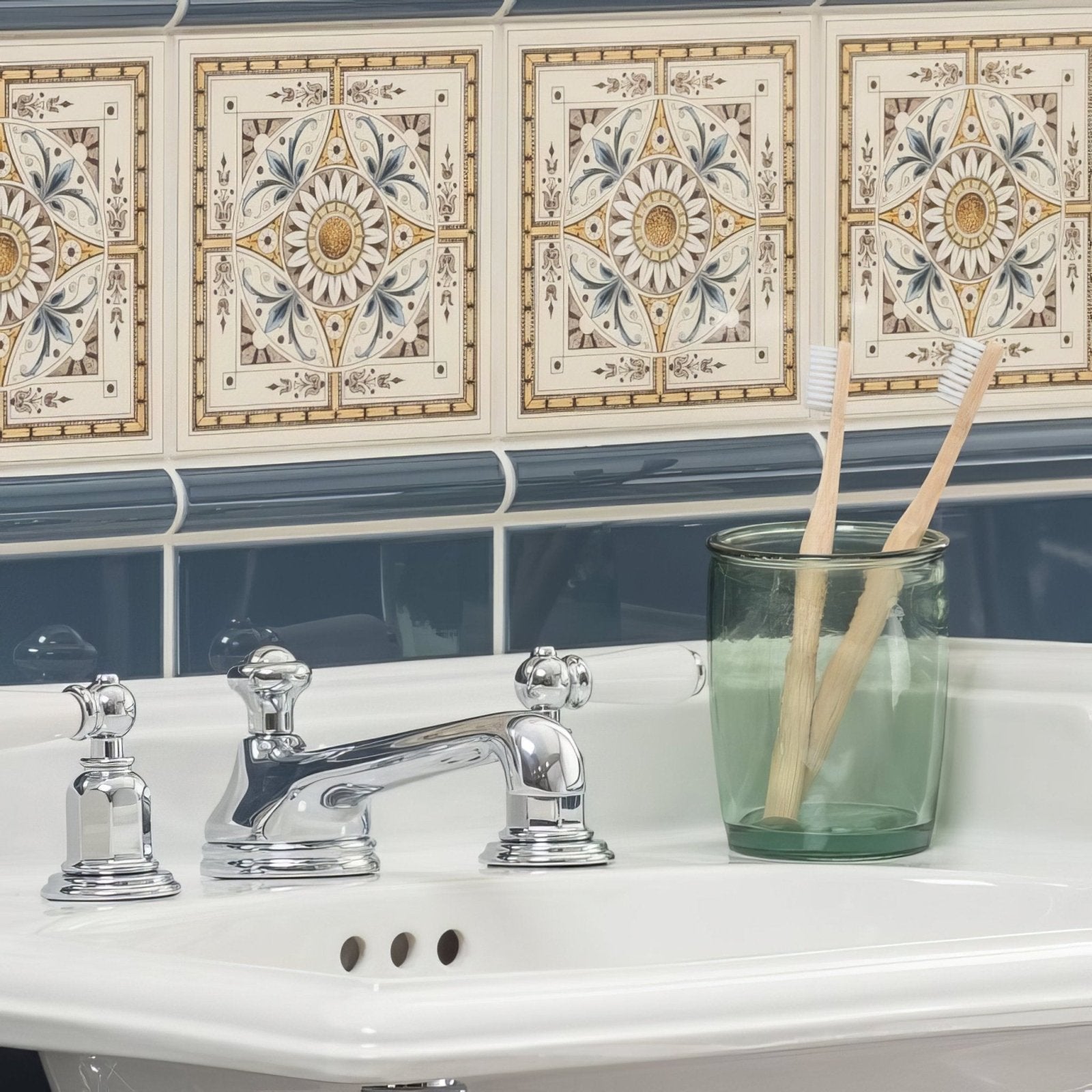 Chrome-finished three-handle bathroom faucet with ornate rounded knobs and polished metallic finish on county white tile