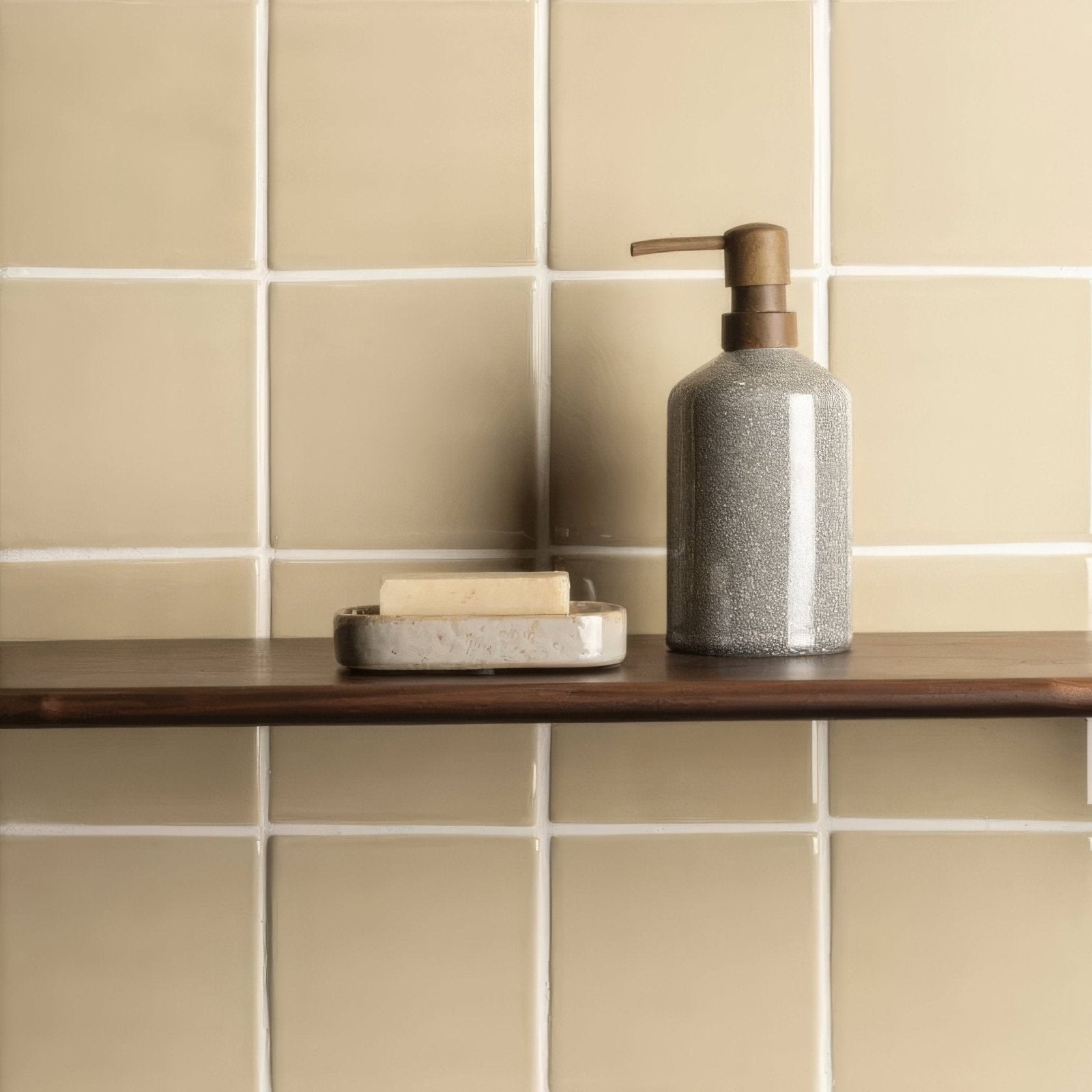 Gray speckled ceramic soap dispenser with a bronze pump for tarragon field tile bathroom decor and use