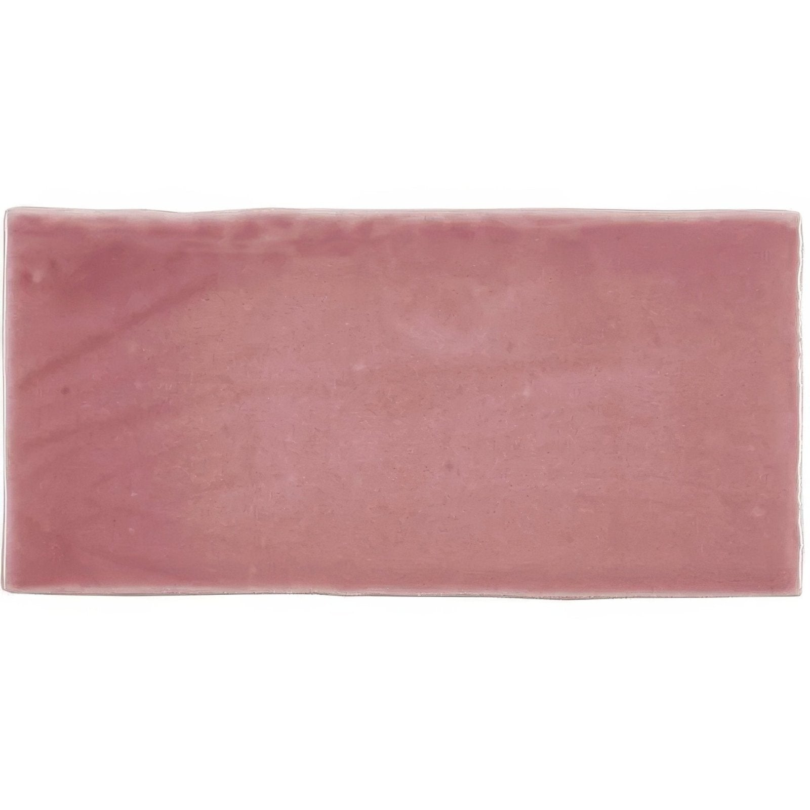 A rectangular pink tayberry half tile made of ceramic with a matte slightly textured surface and subtle hue variations