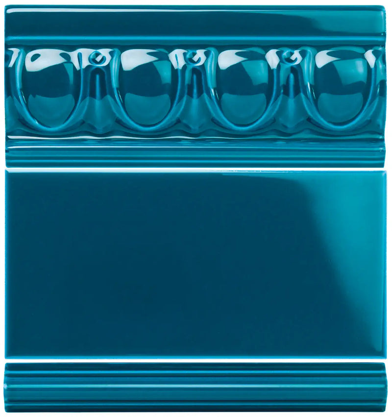 Teal glossy ceramic tile with a decorative beaded border design.
