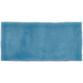 A rectangular blue ceramic half tile teal with a textured crackled glaze finish