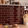 Teapot brown large brick rich glossy burgundy subway tiles with white grout used as sleek kitchen backsplash
