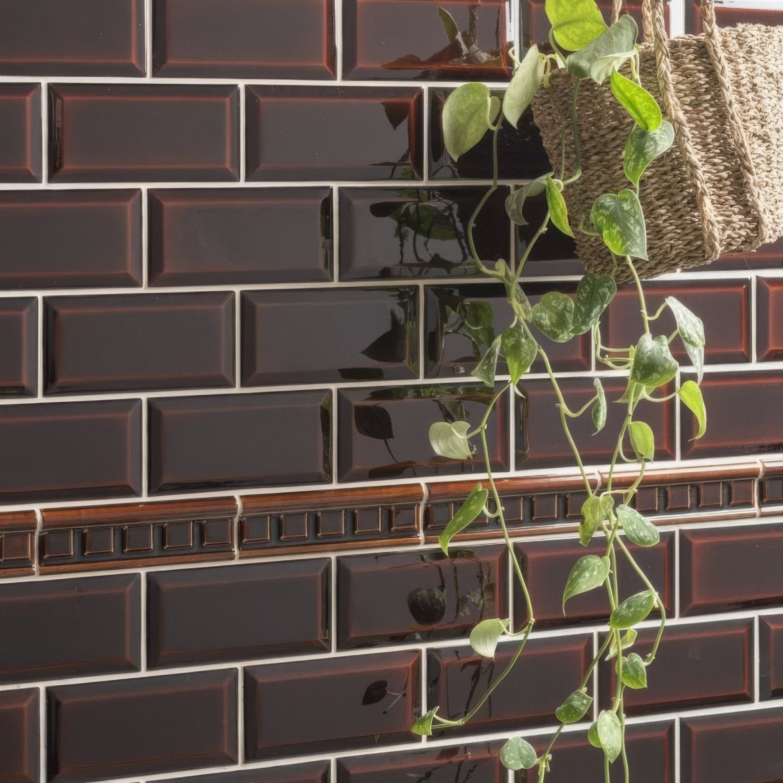 Teapot brown metro bevelled tile featuring dark brown glossy subway tiles with white grout and decorative wooden trim