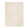 Two stacked beige travertine temple ezra 60 x 40cm tumbled tiles with natural textured surface and subtle veining