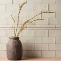 Half tile tern earthenware vase with textured matte gray surface and subtle geometric patterns