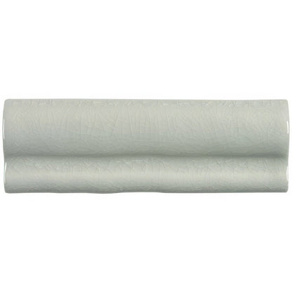 A sleek pale green ceramic torus moulding tern tile with subtle textured surface and gentle wave-like contours