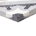 Gray and white terrazzo bertoli tile with textured speckled surface and black aggregate in geometric patterns