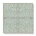 Set of four terrazzo bosello base square tiles with speckled muted sage green finish for flooring and walls