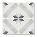 Terrazzo crovato tile with dark gray geometric star pattern on off-white speckled terrazzo background