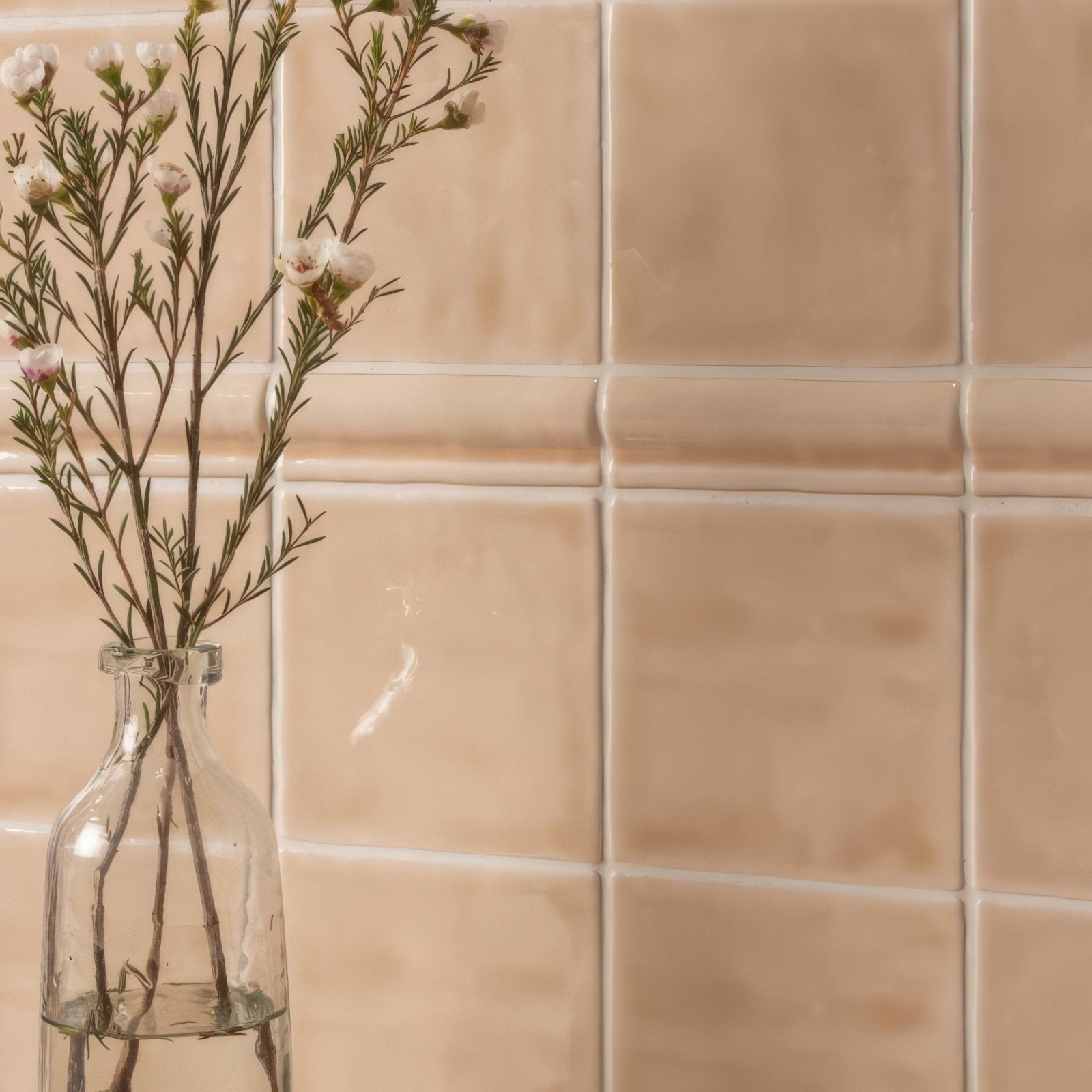 Thebes field tile with a clear glass bottle holding delicate white and pink flowers as decorative accent