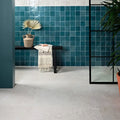 Teal glossy porcelain square tiles with white grout create a striking wall accent in tisbury 80 x 80cm size