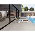 Modern white lounge chair with dark gray cushioning and minimalist design in Tívoli 1828 grey matt finish