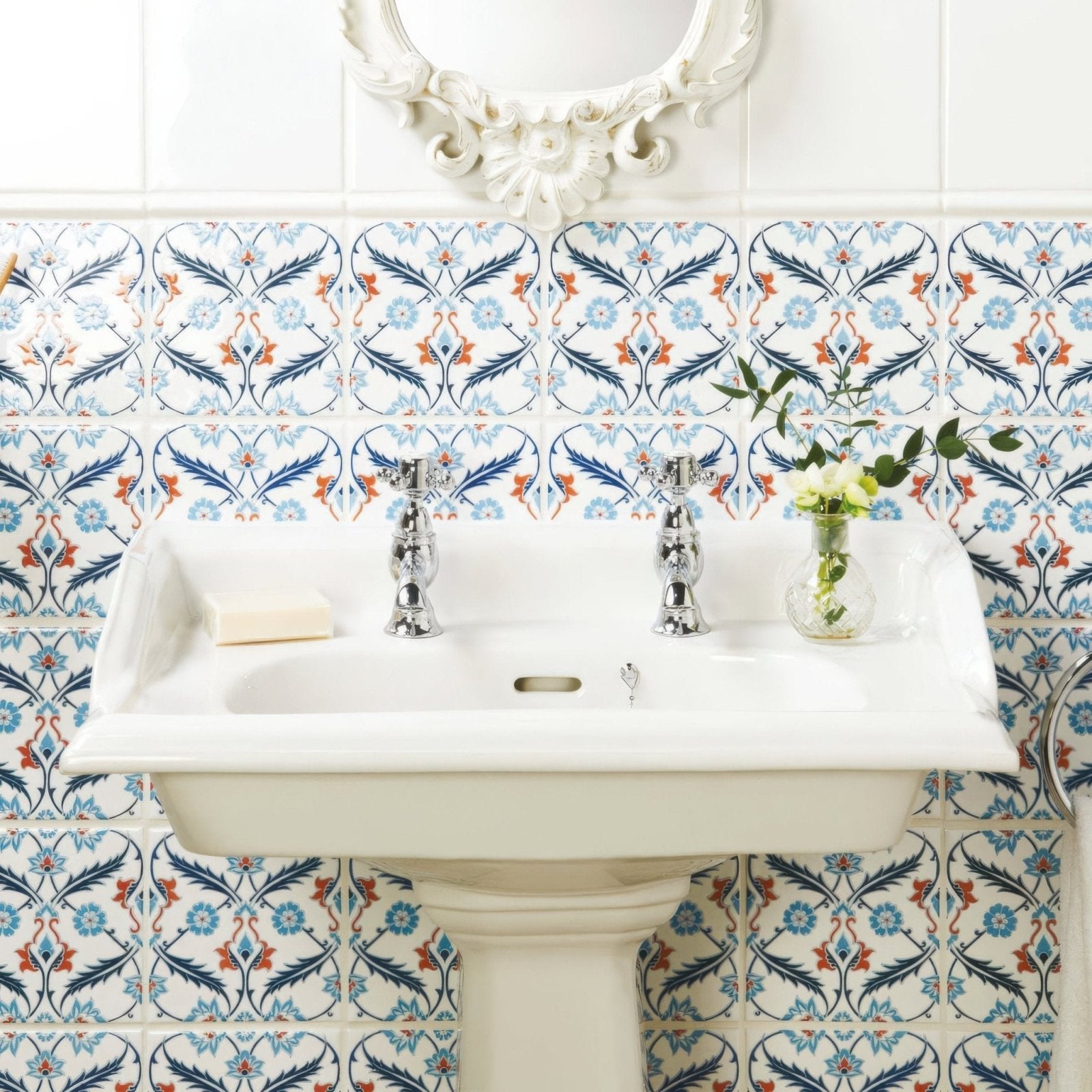 White ceramic pedestal sink with chrome faucets featured in the topkapi red collection on helmingham