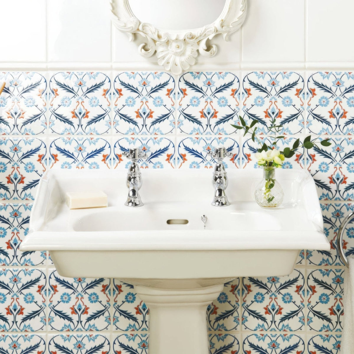White ceramic pedestal sink with chrome faucets featured in the topkapi red collection on helmingham